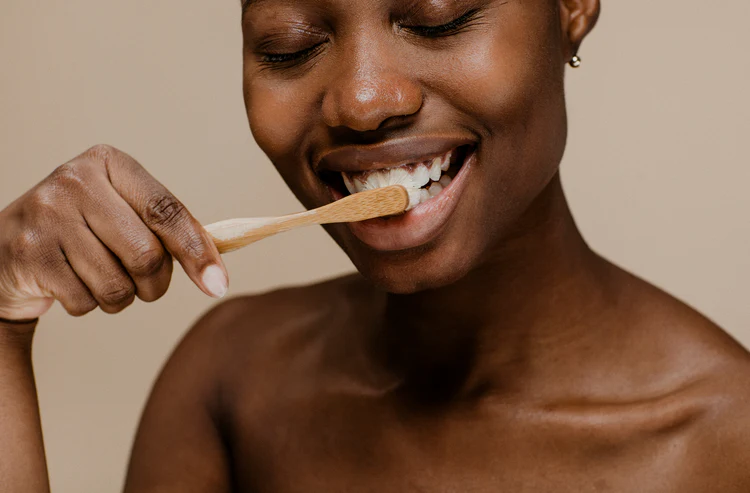 smiling woman brushing her teeth